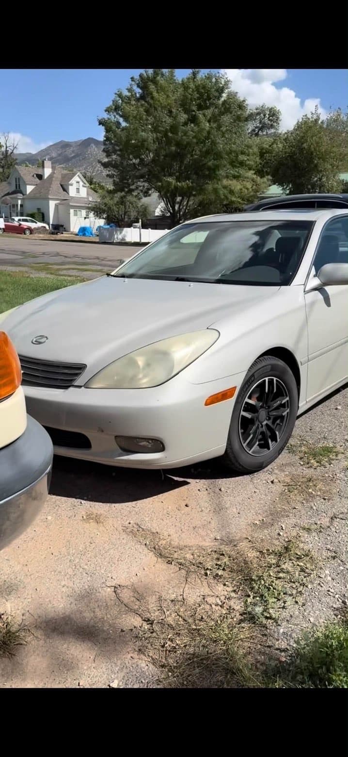 Silver Lexus before restoration with yellow cloudy headlights